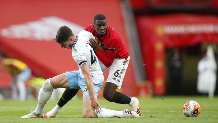 Paul Pogba MANCHESTER, ENGLAND - JULY 22: Paul Pogba of Manchester United and Declan Rice of West Ham United battle for the ball during the Premier League match between Manchester United and West Ham United at Old Trafford on July 22, 2020 in Manchester, England. Football Stadiums around Europe remain empty due to the Coronavirus Pandemic as Government social distancing laws prohibit fans inside venues resulting in all fixtures being played behind closed doors. (Photo by Clive Brunskill/Getty Images)