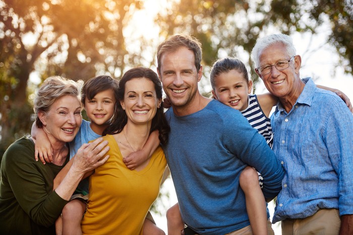 sandwich generation Portrait of a family with two young children posing together outside
