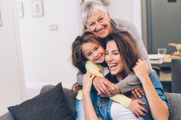 sandwich generation Portrait of a family with two young children posing together outside