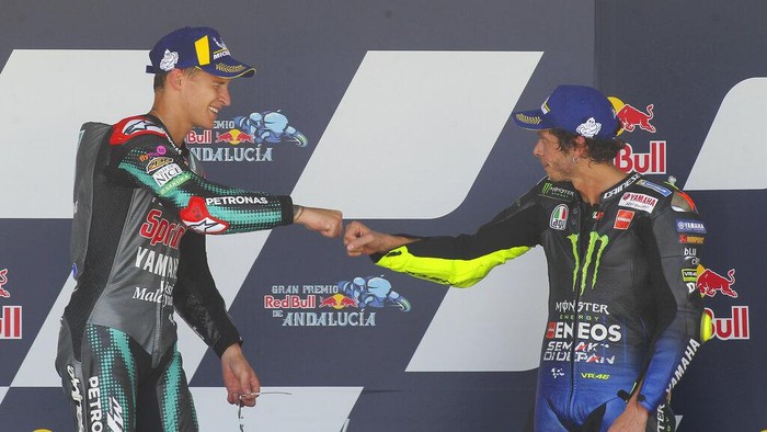 Fabio Quartararo of France, left and Valentino Rossi of Italy touch fists after Quartararo won the race with Rossi finishing 3rd during the MotoGP race during the Andalucia Motorcycle Grand Prix at the Angel Nieto racetrack in Jerez de la Frontera, Spain, Sunday July 26, 2020. (AP Photo/David Clares)