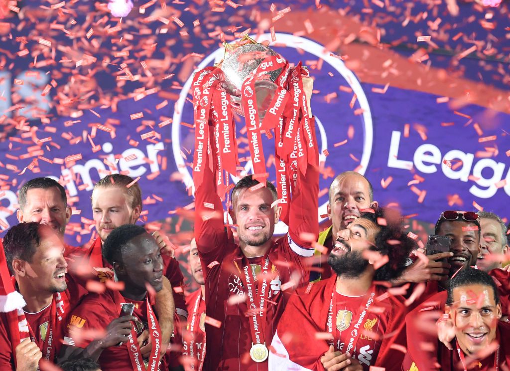 Liverpool LIVERPOOL, ENGLAND - JULY 22: Jordan Henderson of Liverpool holds the Premier League Trophy aloft along side Mohamed Salah as they celebrate winning the League during the presentation ceremony of the Premier League match between Liverpool FC and Chelsea FC at Anfield on July 22, 2020 in Liverpool, England. Football Stadiums around Europe remain empty due to the Coronavirus Pandemic as Government social distancing laws prohibit fans inside venues resulting in games being played behind closed doors. (Photo by Laurence Griffiths/Getty Images)