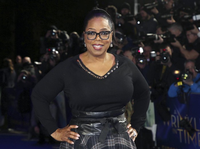 FILE - In this March 13, 2018, file photo, actress Oprah Winfrey poses for photographers upon arrival at the premiere of the film A Wrinkle In Time in London. O, The Oprah Magazine is ending its regular monthly print editions with the December 2020 issue after 20 years of publication. The brand, which is among the most recognizable magazines in the U.S., is not going away but will become more “more digitally-centric, said a Hearst spokeswoman Monday.  (Photo by Joel C Ryan/Invision/AP, File)