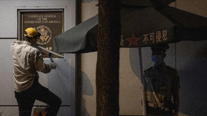 FILE - In this file photo taken Sunday, July 26, 2020, a resident holds up a phone cover depicting U.S. President Donald Trump for a photo outside the United States Consulate in Chengdu in southwest China's Sichuan province. The ongoing sharp deterioration in U.S.-China ties poses risks to both countries and the rest of the world. With the U.S. presidential campaign heating up, all bets are that relations with China will only get worse. At stake are global trade, technology and security. (AP Photo/Ng Han Guan)