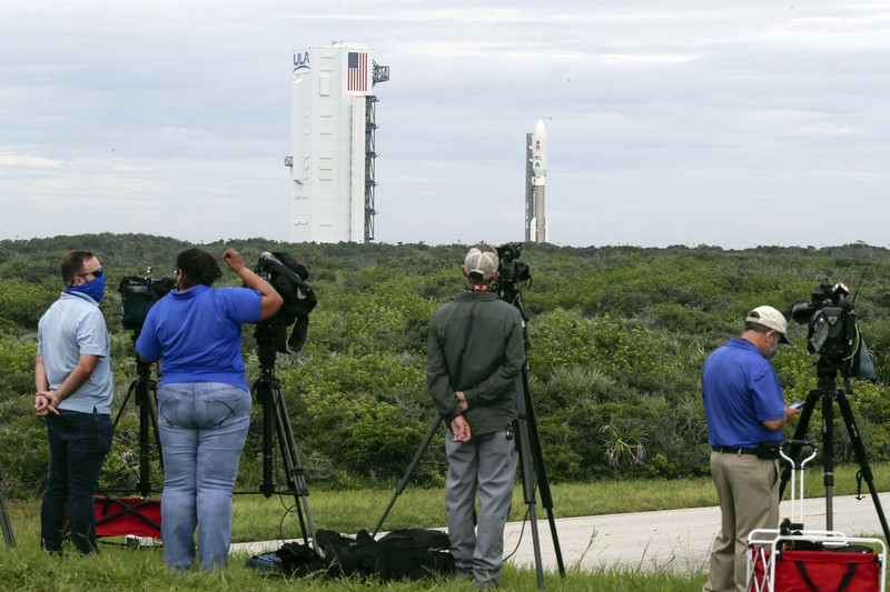 Alexander Mather, of Burke, Va. stands next to a model of the Mars 2020 rover he named in a contest during a news conference at the Kennedy Space Center Tuesday, July 28, 2020, in Cape Canaveral, Fla. Mather, submitted the winning entry in NASA's 