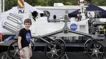 Alexander Mather, bocah pemenang kontes esai Name the Rover, berpose dengan replika Perseverance. Ia adalah sosok di balik terpilihnya nama Perseverance untuk rover tersebut. Foto: AP/John Raoux
