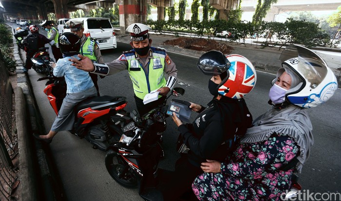 Polisi menggelar Operasi Patuh Jaya 2020, di Jalan DI Pandjaitan, By Pass, Jakarta Timur.  Mereka menindak pemotor yang memasuki jalur cepat.