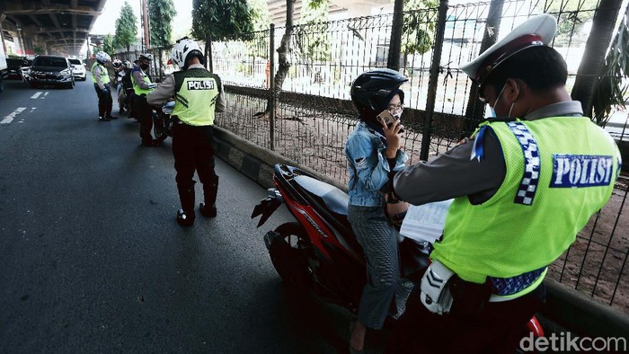 Polisi menggelar Operasi Patuh Jaya 2020, di Jalan DI Pandjaitan, By Pass, Jakarta Timur.  Mereka menindak pemotor yang memasuki jalur cepat.