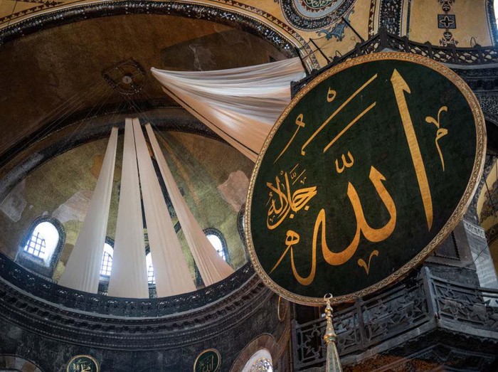 ISTANBUL, TURKEY - JULY 24: Curtains cover a Christian fresco inside the Hagia Sophia Grand Mosque after the first official Friday prayers were held on July 24, 2020 in Istanbul, Turkey. Turkeys President Recep Tayyip Erdogan attended the first Friday prayer inside the Hagia Sophia Mosque after it was officially reconverted into a mosque from a museum. The controversial decision to change the iconic buildings status came after Turkeys highest administrative court voted on July, 10 to revoke the structures status as a museum allowing it to be converted back to a mosque. Throughout its history the UNESCO World Heritage site has served as a Byzantine Cathedral, a mosque under Ottoman rule, and most recently a museum. Thousands of worshippers from all over Turkey flocked to the site for the chance to pray inside the historic building for the first Friday prayers.   (Photo by Chris McGrath/Getty Images)