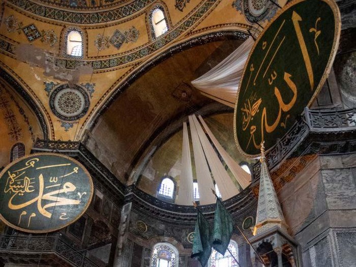 ISTANBUL, TURKEY - JULY 24: Curtains cover a Christian fresco inside the Hagia Sophia Grand Mosque after the first official Friday prayers were held on July 24, 2020 in Istanbul, Turkey. Turkeys President Recep Tayyip Erdogan attended the first Friday prayer inside the Hagia Sophia Mosque after it was officially reconverted into a mosque from a museum. The controversial decision to change the iconic buildings status came after Turkeys highest administrative court voted on July, 10 to revoke the structures status as a museum allowing it to be converted back to a mosque. Throughout its history the UNESCO World Heritage site has served as a Byzantine Cathedral, a mosque under Ottoman rule, and most recently a museum. Thousands of worshippers from all over Turkey flocked to the site for the chance to pray inside the historic building for the first Friday prayers.   (Photo by Chris McGrath/Getty Images)