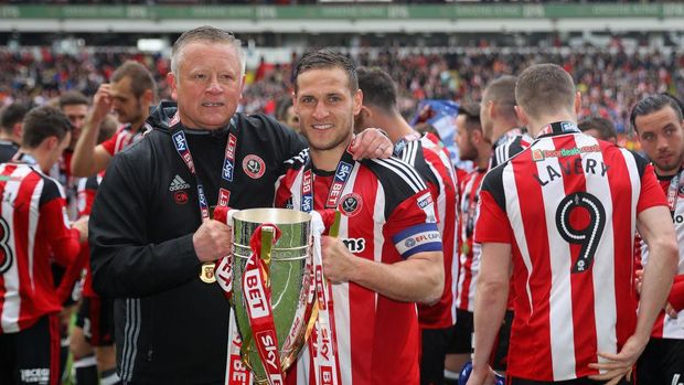 675123256 SHEFFIELD, ENGLAND - APRIL 30: Chris Wilder, Sheffield United manager and Billy Sharp, Captain of Sheffield United celebrate as they win promotion into next seasons Sky Bet Championship afte the Sky Bet League One match between Sheffield United and Chesterfield at Bramall Lane on April 30, 2017 in Sheffield, England. (Photo by Warren Little/Getty Images)