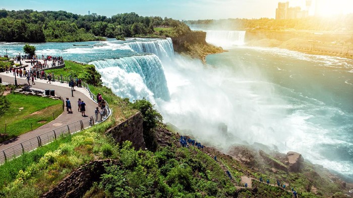 American side of Niagara falls, NY, USA. Tourists enjoying beautiful view to Niagara Falls during hot sunny summer day.