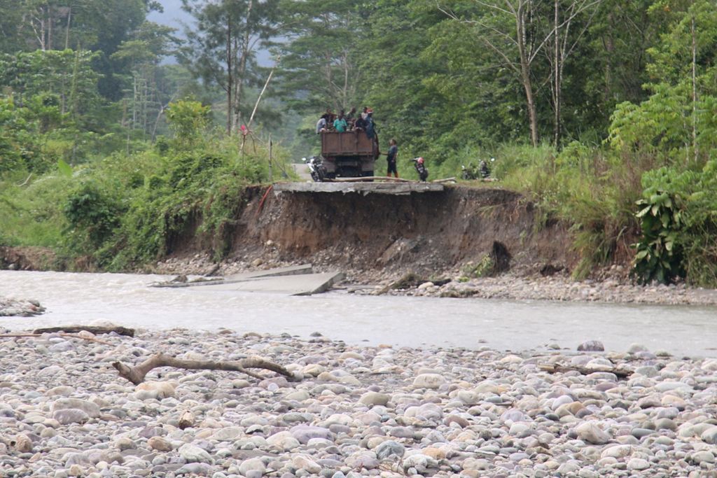 Banjir pada Minggu (26/7) lalu membuat jalan Trans Papua yang hubungkan Kabupaten Mimika-Kabupaten Nabire terputus. Rusaknya jalan itu membuat warga terisolir.