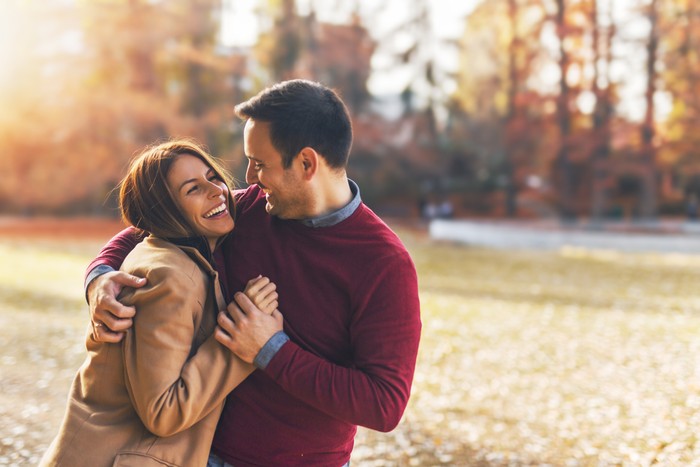 Ilustrasi pasangan suami istri Couple in love hugging and enjoying at public park in autumn