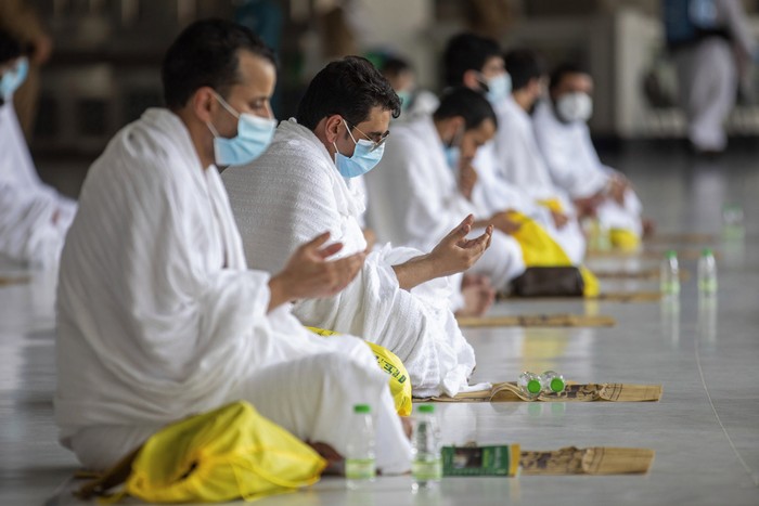 In this photo released by the Saudi Media Ministry, limited numbers of pilgrims, move several feet apart, circling the cube-shaped Kaaba in the first rituals of the hajj, as they keep social distancing to help prevent the spread of the coronavirus, in the Muslim holy city of Mecca, Saudi Arabia, Wednesday, July 29, 2020. The hajj, which started on Wednesday, is intended to bring about greater humility and unity among Muslims. (Saudi Media Ministry via AP)