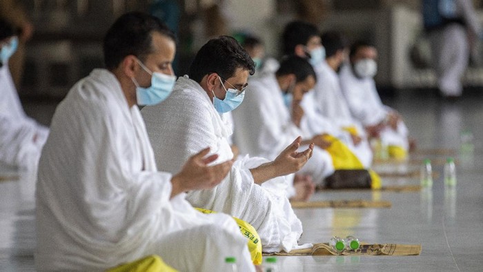 In this photo released by the Saudi Media Ministry, a limited numbers of pilgrims pray in the first rituals of the hajj, as they keep social distancing to limit exposure and the potential transmission of the coronavirus, at the Grand Mosque in the Muslim holy city of Mecca, Saudi Arabia, Wednesday, July 29, 2020. A unique and scaled-down hajj started on Wednesday. (Saudi Media Ministry via AP)