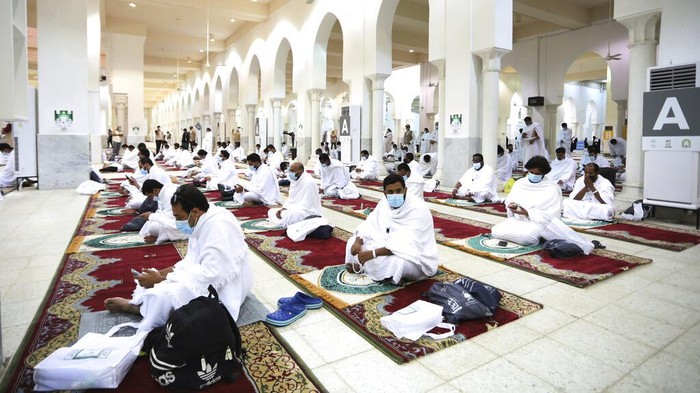 Muslim pilgrims pray inside the Namira Mosque in Arafat as they keep social distance to protect themselves against coronavirus during the annual hajj pilgrimage near the holy city of Mecca, Saudi Arabia, Thursday, July 30, 2020. This years hajj was dramatically scaled down from 2.5 million pilgrims to as few as 1,000 due to the coronavirus pandemic. (AP Photo)