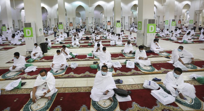 Saudi Hajj Muslim pilgrims pray inside the Namira Mosque in Arafat as they keep social distance to protect themselves against coronavirus during the annual hajj pilgrimage near the holy city of Mecca, Saudi Arabia, Thursday, July 30, 2020. This year's hajj was dramatically scaled down from 2.5 million pilgrims to as few as 1,000 due to the coronavirus pandemic. (AP Photo)