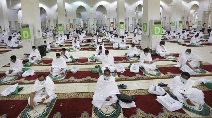 Muslim pilgrims pray inside the Namira Mosque in Arafat as they keep social distance to protect themselves against coronavirus during the annual hajj pilgrimage near the holy city of Mecca, Saudi Arabia, Thursday, July 30, 2020. This years hajj was dramatically scaled down from 2.5 million pilgrims to as few as 1,000 due to the coronavirus pandemic. (AP Photo)