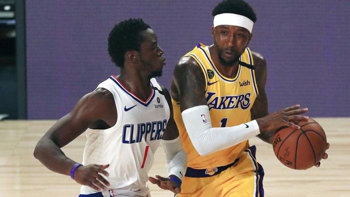 Los Angeles Lakers Kentavious Caldwell-Pope, right, collides with Los Angeles Clippers Reggie Jackson, left, during an NBA basketball game Thursday, July 30, 2020, in Lake Buena Vista, Fla. (Mike Ehrmann/Pool Photo via AP)