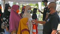 Sejumlah warga mengantre untuk diukur suhu tubuhnya dengan menggunakan thermal gun saat hendak berwisata ke makam Kesultanan Banten di Kasemen, Serang. Sejumlah protokol kesehatan wajib dipatuhi oleh para pengunjung tempat wisata guna mencegah penyebaran virus Corona.