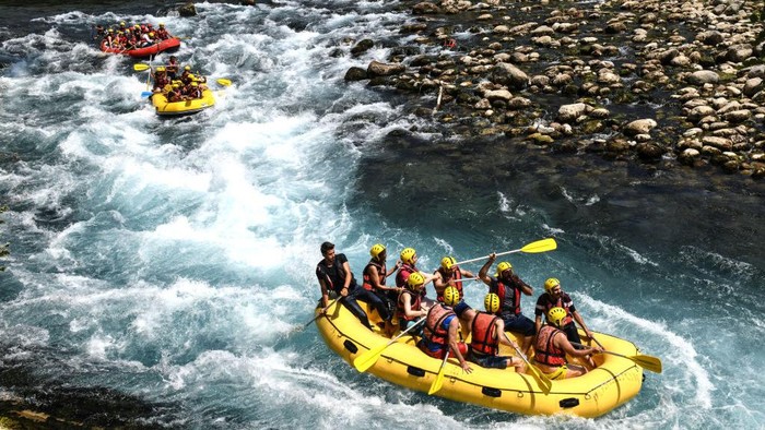 MANAVGAT, TURKEY - AUGUST 18: People take part in white water rafting on the river in Koprulu Canyon on August 18, 2019 in Manavgat, Turkey. Turkey’s resort towns saw a 100 percent occupancy rate with the Eid al-Adha holiday, including the southern province of Antalya and Aegean province of Muğla, the top two favorite destinations of both domestic and foreign tourists. According to country's statistical authority Turkey's tourism revenue hit nearly $8 billion in the second quarter of this year. (Photo by Burak Kara/Getty Images)