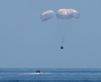 NASA astronauts Robert Behnken, left, and Douglas Hurley are seen inside the SpaceX Crew Dragon Endeavour spacecraft onboard the SpaceX GO Navigator recovery ship shortly after having landed in the Gulf of Mexico off the coast of Pensacola, Fla., Sunday, Aug. 2, 2020. The Demo-2 test flight for NASAs Commercial Crew Program was the first to deliver astronauts to the International Space Station and return them safely to Earth onboard a commercially built and operated spacecraft. Behnken and Hurley returned after spending 64 days in space. (Bill Ingalls/NASA via AP)
