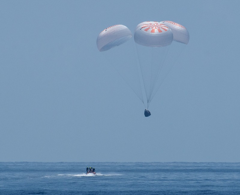 NASA astronauts Robert Behnken, left, and Douglas Hurley are seen inside the SpaceX Crew Dragon Endeavour spacecraft onboard the SpaceX GO Navigator recovery ship shortly after having landed in the Gulf of Mexico off the coast of Pensacola, Fla., Sunday, Aug. 2, 2020. The Demo-2 test flight for NASA's Commercial Crew Program was the first to deliver astronauts to the International Space Station and return them safely to Earth onboard a commercially built and operated spacecraft. Behnken and Hurley returned after spending 64 days in space. (Bill Ingalls/NASA via AP)