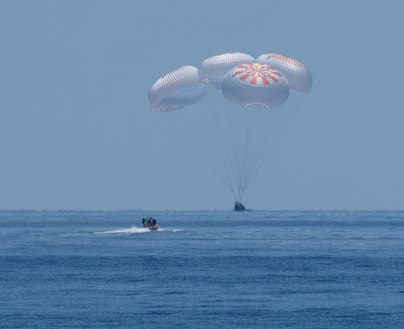 NASA astronauts Robert Behnken, left, and Douglas Hurley are seen inside the SpaceX Crew Dragon Endeavour spacecraft onboard the SpaceX GO Navigator recovery ship shortly after having landed in the Gulf of Mexico off the coast of Pensacola, Fla., Sunday, Aug. 2, 2020. The Demo-2 test flight for NASA's Commercial Crew Program was the first to deliver astronauts to the International Space Station and return them safely to Earth onboard a commercially built and operated spacecraft. Behnken and Hurley returned after spending 64 days in space. (Bill Ingalls/NASA via AP)
