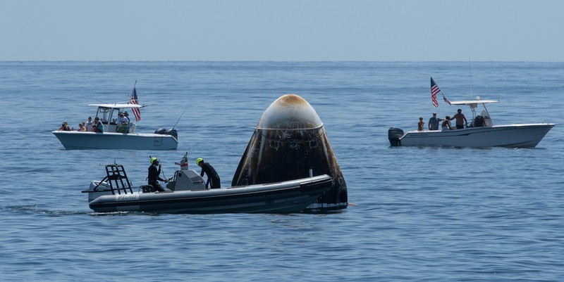 NASA astronauts Robert Behnken, left, and Douglas Hurley are seen inside the SpaceX Crew Dragon Endeavour spacecraft onboard the SpaceX GO Navigator recovery ship shortly after having landed in the Gulf of Mexico off the coast of Pensacola, Fla., Sunday, Aug. 2, 2020. The Demo-2 test flight for NASA's Commercial Crew Program was the first to deliver astronauts to the International Space Station and return them safely to Earth onboard a commercially built and operated spacecraft. Behnken and Hurley returned after spending 64 days in space. (Bill Ingalls/NASA via AP)