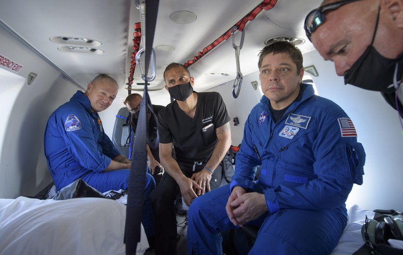 NASA astronauts Robert Behnken, left, and Douglas Hurley are seen inside the SpaceX Crew Dragon Endeavour spacecraft onboard the SpaceX GO Navigator recovery ship shortly after having landed in the Gulf of Mexico off the coast of Pensacola, Fla., Sunday, Aug. 2, 2020. The Demo-2 test flight for NASA's Commercial Crew Program was the first to deliver astronauts to the International Space Station and return them safely to Earth onboard a commercially built and operated spacecraft. Behnken and Hurley returned after spending 64 days in space. (Bill Ingalls/NASA via AP)