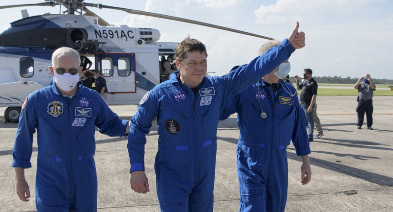 NASA astronauts Robert Behnken, left, and Douglas Hurley are seen inside the SpaceX Crew Dragon Endeavour spacecraft onboard the SpaceX GO Navigator recovery ship shortly after having landed in the Gulf of Mexico off the coast of Pensacola, Fla., Sunday, Aug. 2, 2020. The Demo-2 test flight for NASA's Commercial Crew Program was the first to deliver astronauts to the International Space Station and return them safely to Earth onboard a commercially built and operated spacecraft. Behnken and Hurley returned after spending 64 days in space. (Bill Ingalls/NASA via AP)