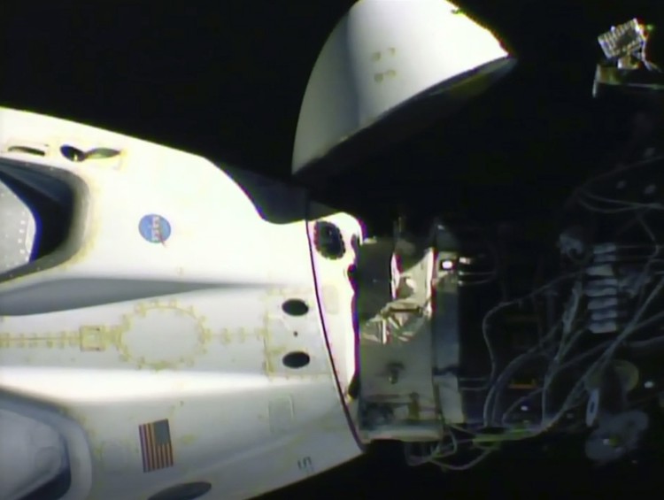 NASA astronauts Robert Behnken, left, and Douglas Hurley are seen inside the SpaceX Crew Dragon Endeavour spacecraft onboard the SpaceX GO Navigator recovery ship shortly after having landed in the Gulf of Mexico off the coast of Pensacola, Fla., Sunday, Aug. 2, 2020. The Demo-2 test flight for NASAs Commercial Crew Program was the first to deliver astronauts to the International Space Station and return them safely to Earth onboard a commercially built and operated spacecraft. Behnken and Hurley returned after spending 64 days in space. (Bill Ingalls/NASA via AP)