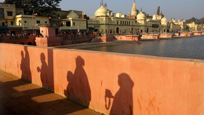 India Temple Dispute FILE-In this Nov. 11, 2019 file photo, Hindu devotees pray while walking towards a temple, in Ayodhya, India. India’s Prime Minister Narendra Modi will attend a groundbreaking ceremony next month for a Hindu temple on a disputed site in northern India where a 16th-century mosque was torn down by Hindu hard-liners in 1992. The trust overseeing the temple construction says the ceremony is set for Aug. 5, a date they say is astrologically auspicious for Hindus but that also marks a year since the Indian Parliament revoked the semi-autonomous status of its only Muslim-majority state, Jammu and Kashmir. (AP Photo/Rajesh Kumar Singh, File)