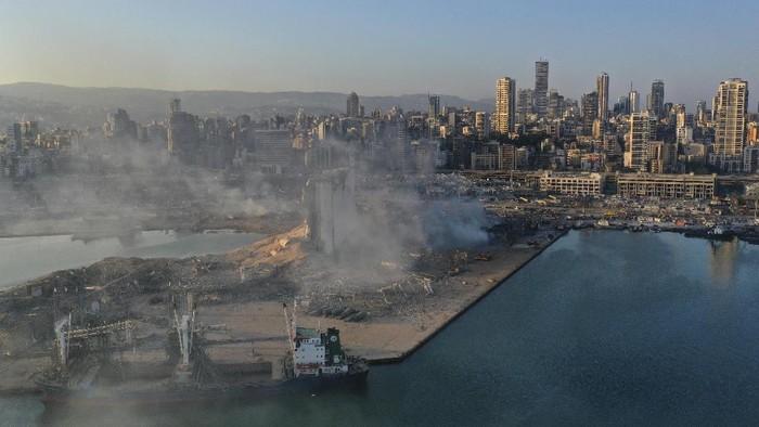 A drone picture shows smoke from the scene of an explosion at the seaport of Beirut, Lebanon, Wednesday, Aug. 5, 2020. A massive explosion rocked Beirut on Tuesday, flattening much of the citys port, damaging buildings across the capital and sending a giant mushroom cloud into the sky. (AP Photo/Hussein Malla)