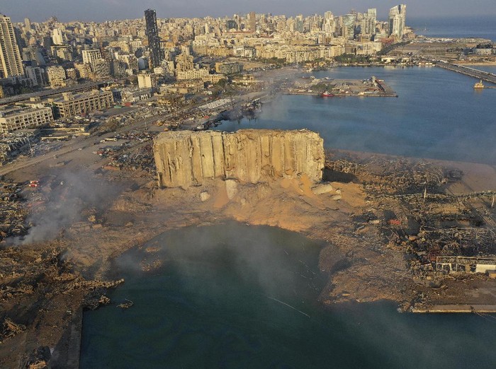 A drone picture shows smoke from the scene of an explosion at the seaport of Beirut, Lebanon, Wednesday, Aug. 5, 2020. A massive explosion rocked Beirut on Tuesday, flattening much of the citys port, damaging buildings across the capital and sending a giant mushroom cloud into the sky. (AP Photo/Hussein Malla)