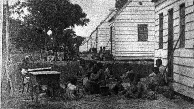 A group of slave children sit around behind the shacks in which they are forced to live on a plantation, South Carolina, 1860. (Photo by Hulton Archive/Getty Images)