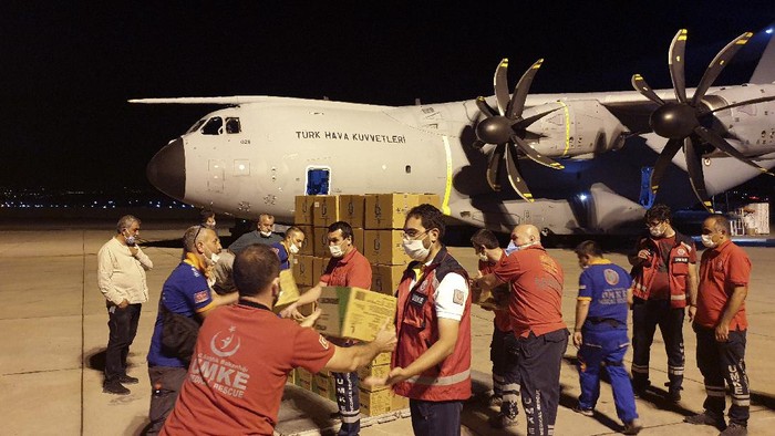 In this photo provided by Turkish Defense Ministry, rescue workers load boxes into a cargo plane at a military airport near Ankara, Turkey, late Wednesday, Aug. 5, 2020. Turkey sent rescue teams and aid to Beirut after an explosion in the Lebanese capitals port killed more than 100 people and injured thousands on Tuesday. (Turkish Defense Ministry via AP, Pool)