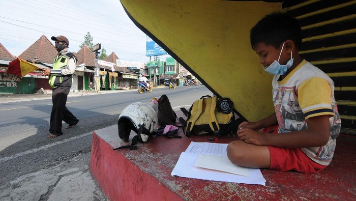 Pengatur Jalan di Boyolali Kerja Sambil Bimbing Anak Belajar Online Seorang pengatur jalan atau Supeltas bekerja sambil mengajak serta anaknya. Hal itu ia lakukan agar dapat bimbing sang anak saat ikuti kegiatan belajar online.