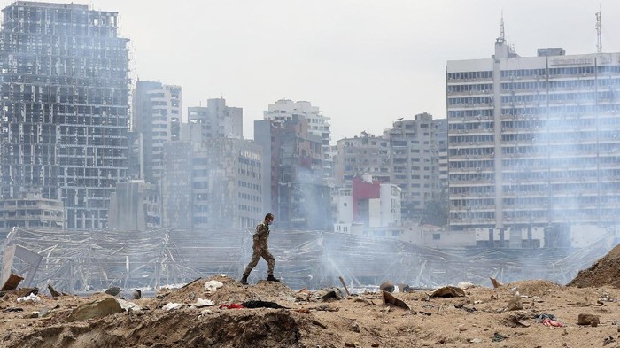 A soldier walks at the devastated site of the explosion in the port of Beirut, Lebanon, Thursday Aug.6, 2020. French President Emmanuel Macron came in Beirut to offer French support to Lebanon after the deadly port blast.(AP Photo/Thibault Camus, Pool)