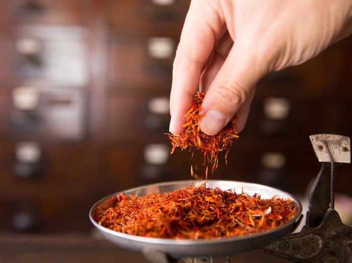 Safflower for diet tea and healthy low fat cooking oil herbal in herb store background