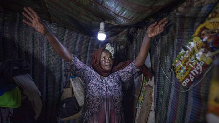 Virus Outbreak Extreme Poverty Rise Mother of two Amsale Hailemariam, a domestic worker who lost work because of the coronavirus, hangs clothes after washing them outside her small tent in the capital Addis Ababa, Ethiopia on Friday, June 26, 2020. The virus arrived, and dreams faded for families, and entire countries. The world could see its first increase in extreme poverty in 22 years, further sharpening social inequities. (AP Photo/Mulugeta Ayene)