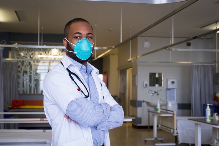 1210962139 Portrait of a young male healthcare worker wearing a protective mask. The corona virus outbreak around the world is a serious pandemic. Confident male doctor with face mask