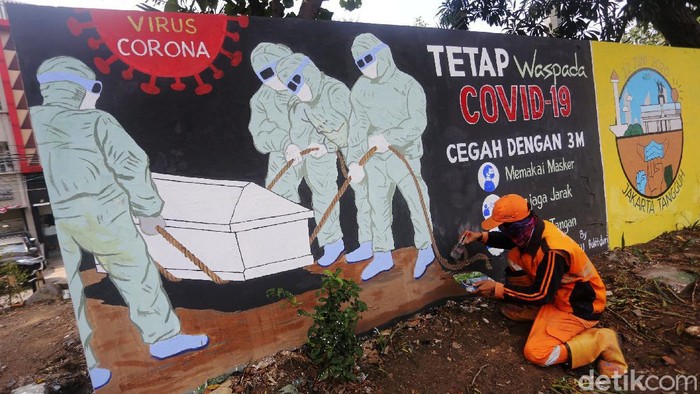 Petugas Pekerja Penanganan Sarana dan Prasarana Umum (PPSU) Kelurahan Bukit Duri, Jakarta menyelesaikan pembuatan mural tentang Covid-19, Jakarta, Selasa  (11/8/2020). Jumlah pasien positif Covid-19 di DKI Jakarta per Senin (10/8/2020) adalah 26.162 orang. Angka ini tertinggi di Indonesia. Dari total kasus positif itu, 16.446 orang dinyatakan telah sembuh, sedangkan 940 orang dilaporkan meninggal dunia. Sementara itu, sebanyak 8.807 pasien masih menjalani perawatan di rumah sakit maupun menjalani isolasi mandiri.