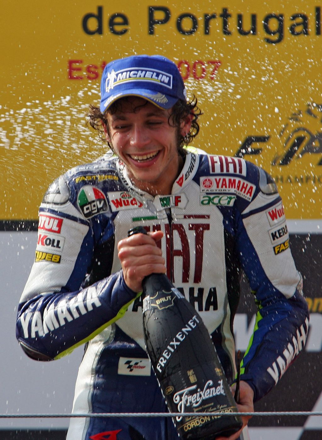 ESTORIL, PORTUGAL - SEPTEMBER 16:  Valentino Rossi of Italy celebrates on the podium after winning the MotoGP class race in the MotoGP of Portugal at the Estoril racetrack on September 16, 2007 in Estoril, Portugal.  (Photo by Denis Doyle/Getty Images)