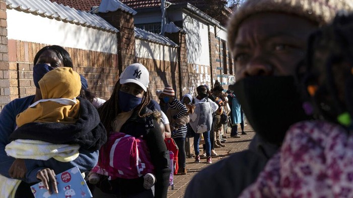 A nurse stands next to a HIV-positive patient outside a gazebo used as a mobile HIV clinic in Ngodwana, South Africa, Thursday, July 2, 2020. Across Africa and around the world, the COVID-19 pandemic has disrupted the supply of antiretroviral drugs to many of the more than 24 million people who take them, endangering their lives. An estimated 7.7 million people in South Africa are HIV positive, the largest number in the world, and 62% of them take the antiretroviral drugs that suppress the virus and prevent transmission. (AP Photo/Bram Janssen)