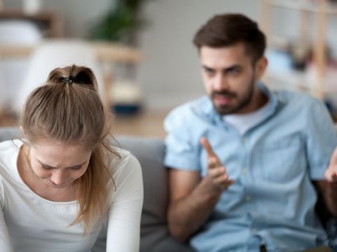 couple Young asian woman is upset that man uses phone all the time without paying attention to her. Man holds phone pay attention on smart mobile phone while sit on bed with ignoring on his girlfriend.