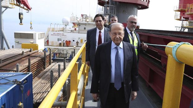 In this photo released by Lebanon's official government photographer Dalati Nohra, Lebanese President Michel Aoun, foreground, and Lebanese Prime Minister Hassan Diab, background left, walk aboard the drilling ship Tungsten Explorer which will be conducting drilling operations of the first exploration well, located approximately 30 kilometers (18 miles) offshore from the capital Beirut Lebanon, Thursday, Feb. 27, 2020. Aoun inaugurated the Mediterranean country's first offshore exploratory drilling for oil and gas, calling it a 