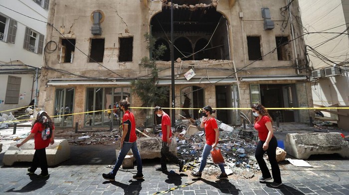 Lebanon Helping Themselves People who volunteered to help clean damaged homes and give other assistance, gather on a street that was damaged by last weeks explosion, in Beirut, Lebanon, Tuesday, Aug. 11, 2020. The explosion that tore through Beirut left around a quarter of a million people with homes unfit to live in. In the absence of the state, residents of Beirut opened their homes to relatives, friends and neighbors. And on the streets, it was young volunteers with brooms and shovels, not government workers, who cleared the littered streets. (AP Photo/Hussein Malla)