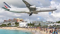 Walaupun pesawat terbang begitu rendah, turis yang wisata di Pantai Maho tidak lantas mengosongkan wilayah pantai. (iStock)