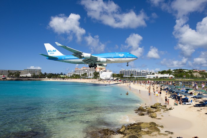 St Maarten, Netherlands - February 13, 2016: beach observe low flying airplanes landing near Maho Beach on island of St Maarten in the Caribbean
